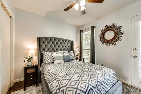 a bedroom with a bed and a ceiling fan