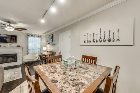 a dining room with a table and chairs and a fireplace