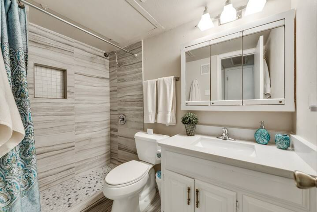 a bathroom with a toilet sink and a mirror