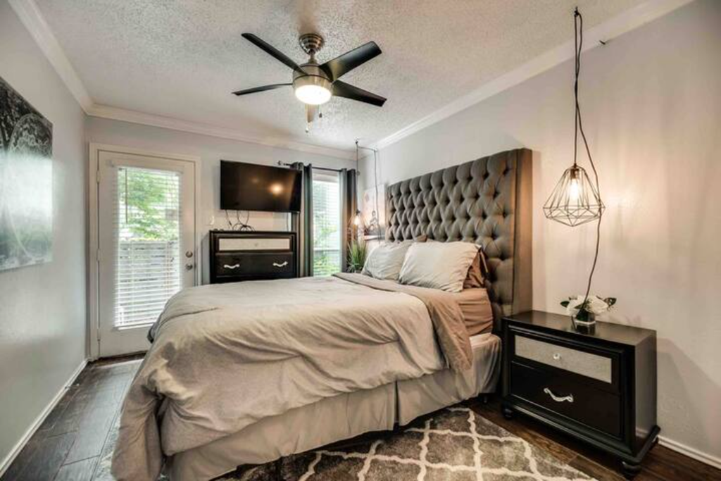 a bedroom with a bed and a ceiling fan