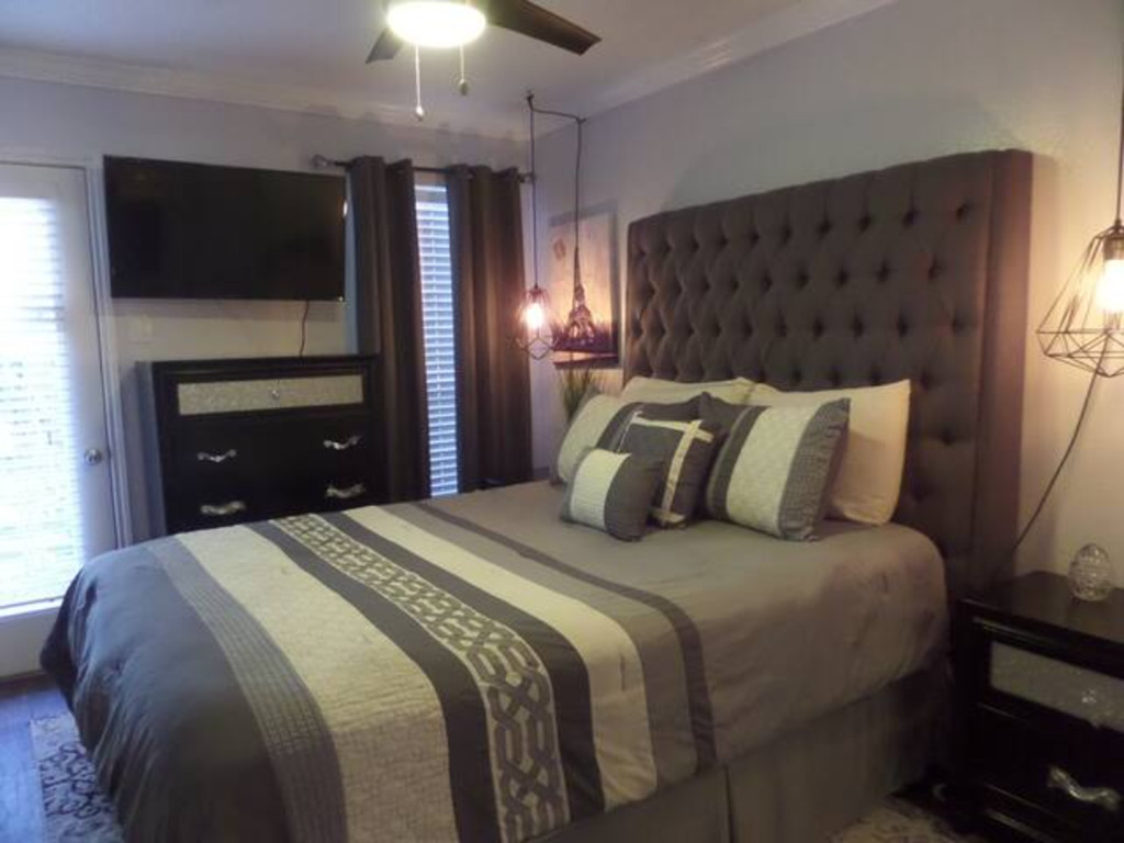 a bedroom with a large bed and a tv