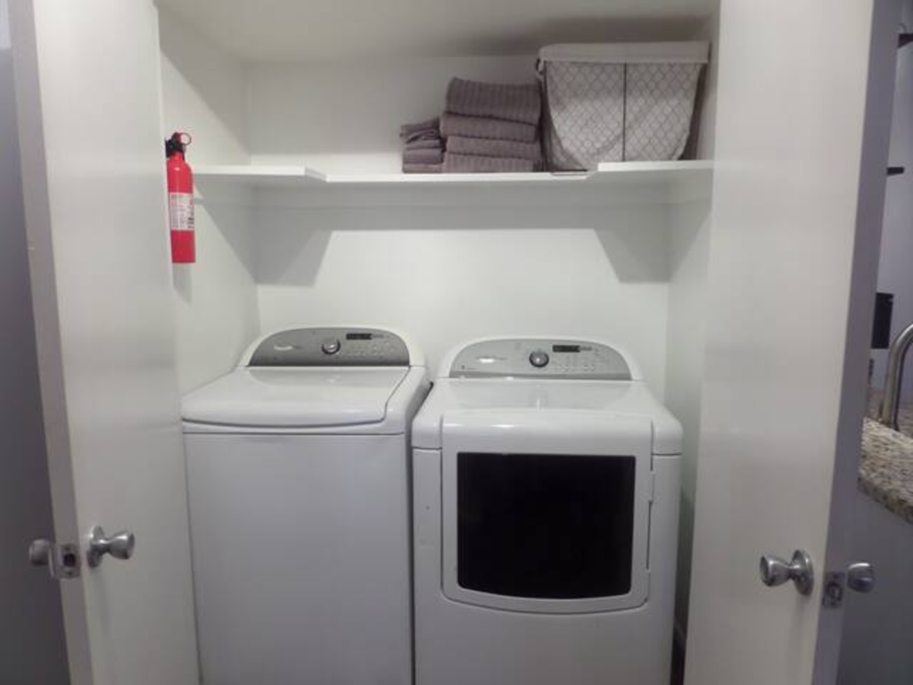 a white washer and dryer in a small laundry room