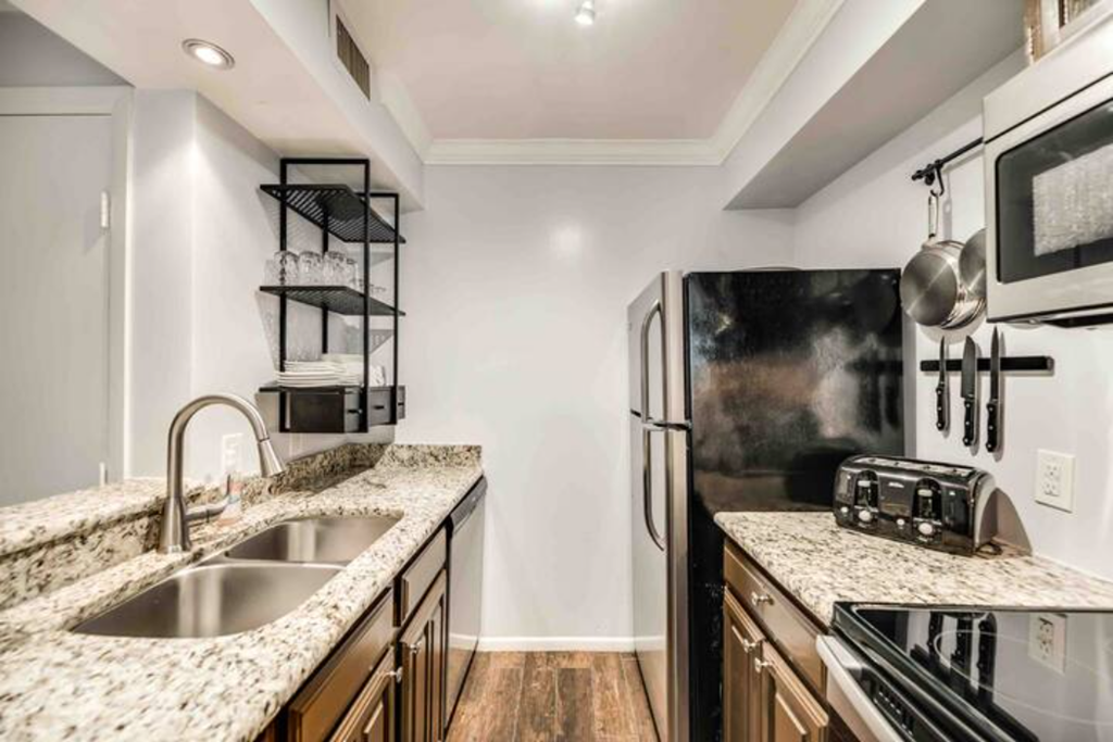 a kitchen with a sink and a refrigerator