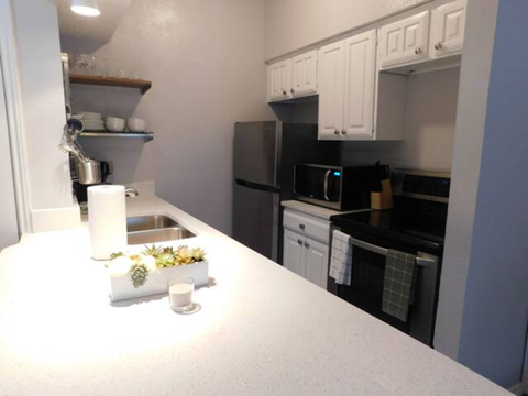 a kitchen with a white counter top