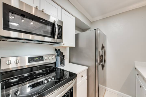 a kitchen with stainless steel appliances and a refrigerator