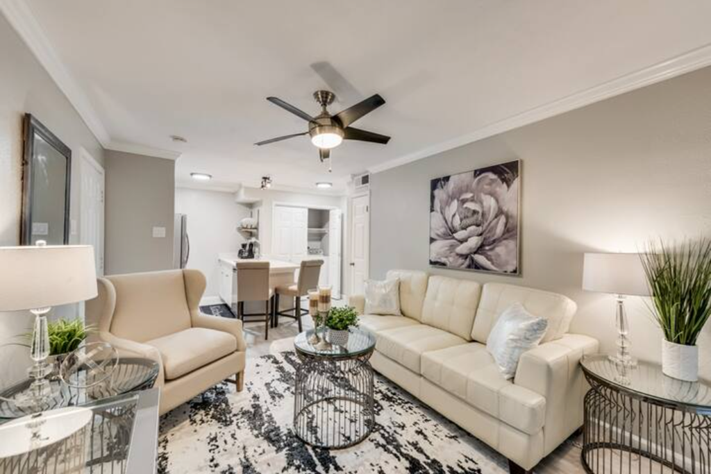 a living room with a couch and a ceiling fan