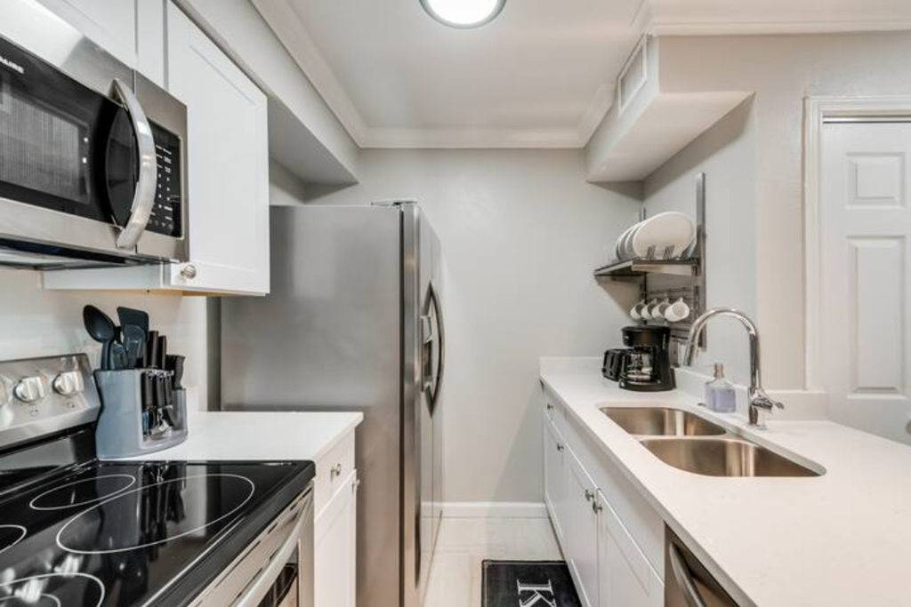a kitchen with a sink and a refrigerator