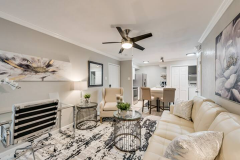 a living room with a couch and a ceiling fan