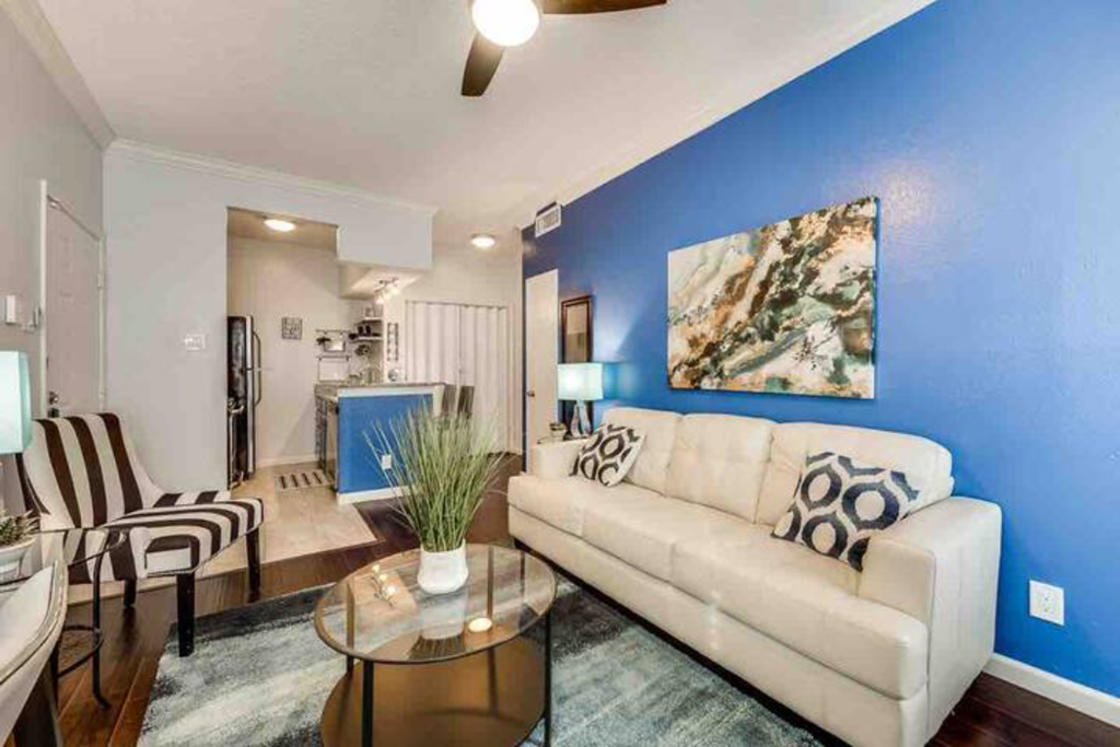 a living room with a blue wall and a white couch