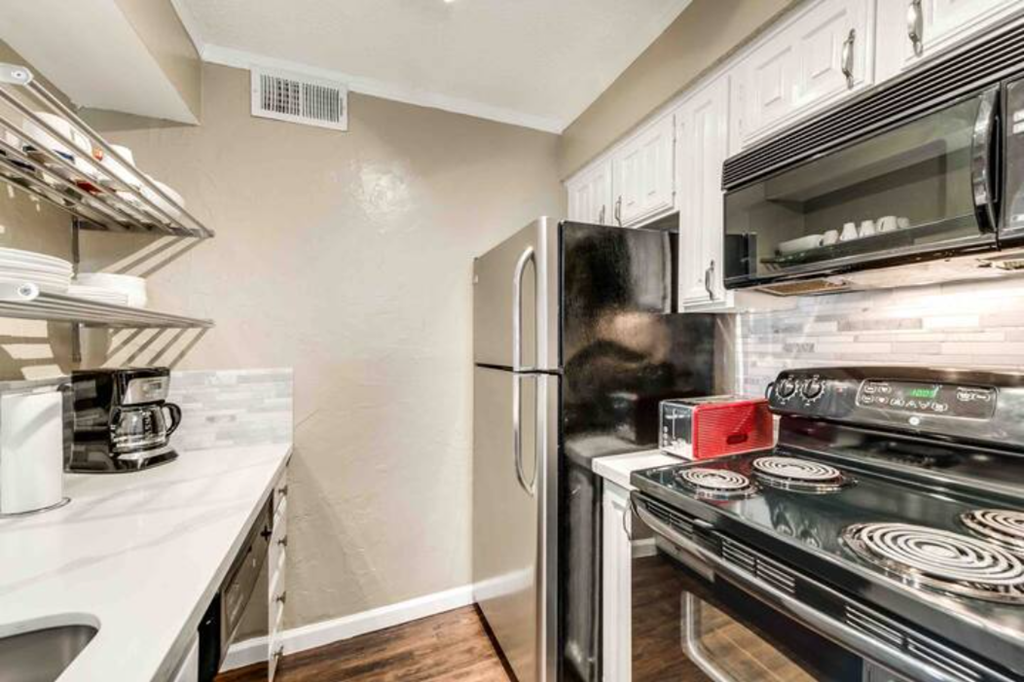 a kitchen with stainless steel appliances and a refrigerator