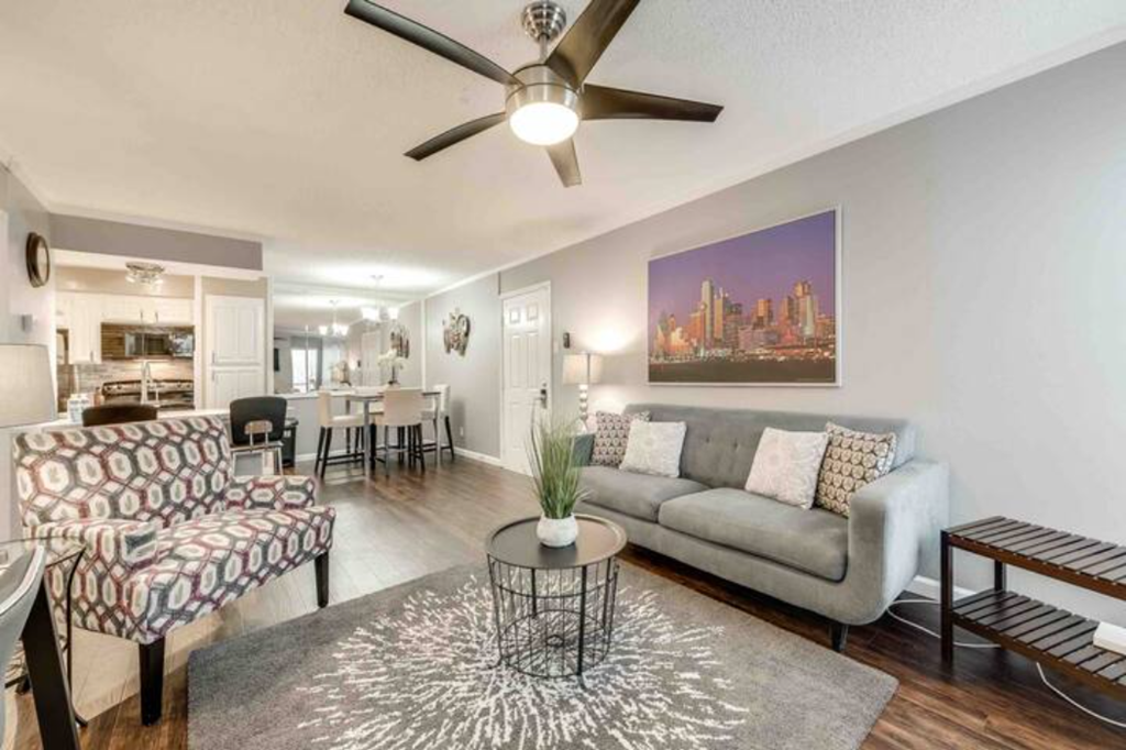 a living room with a couch and a ceiling fan