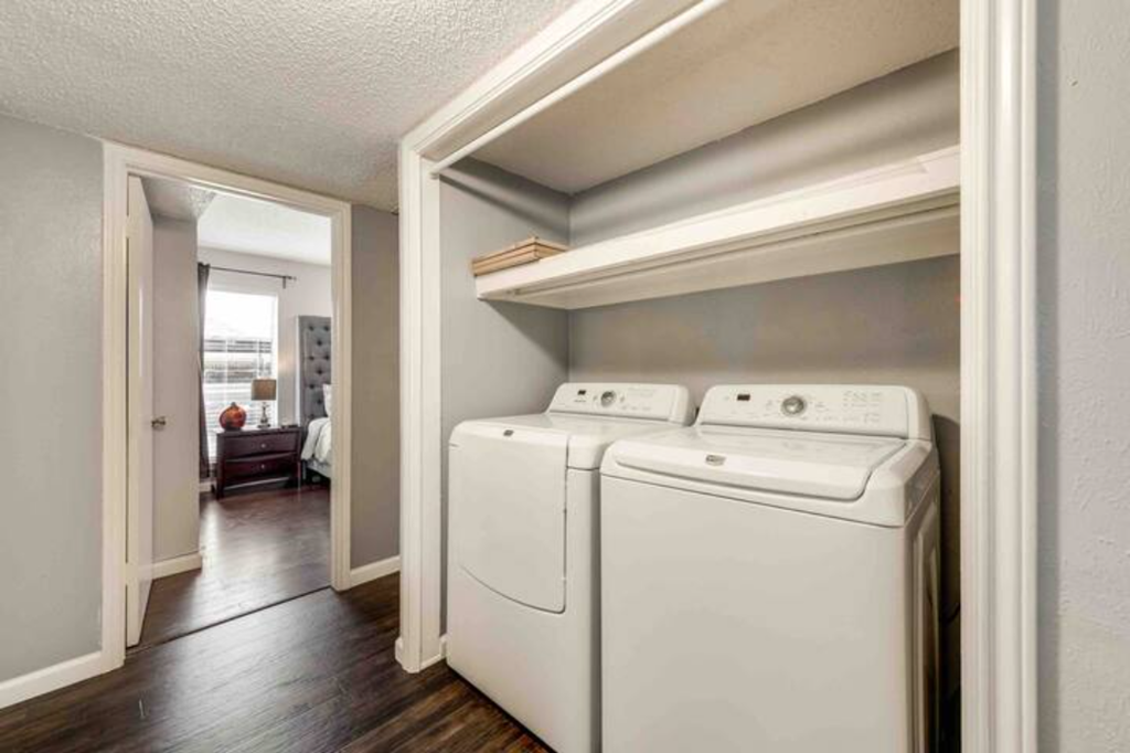 a white washer and dryer in an empty laundry room