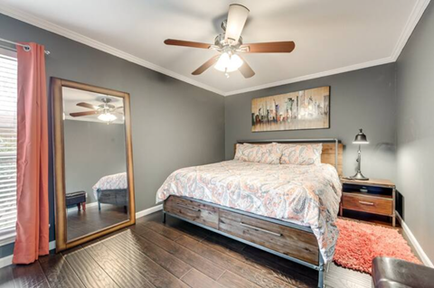 a bedroom with a bed and a ceiling fan