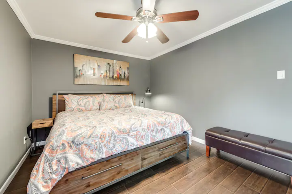a bedroom with a bed and a ceiling fan