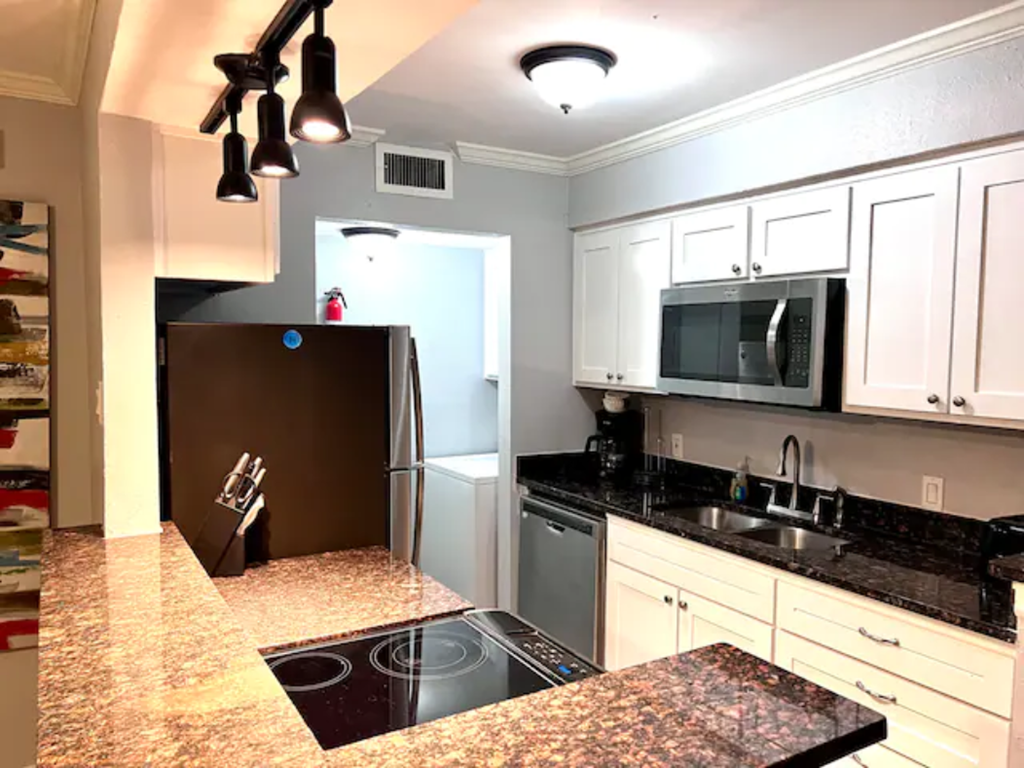 a kitchen with a counter top and a refrigerator