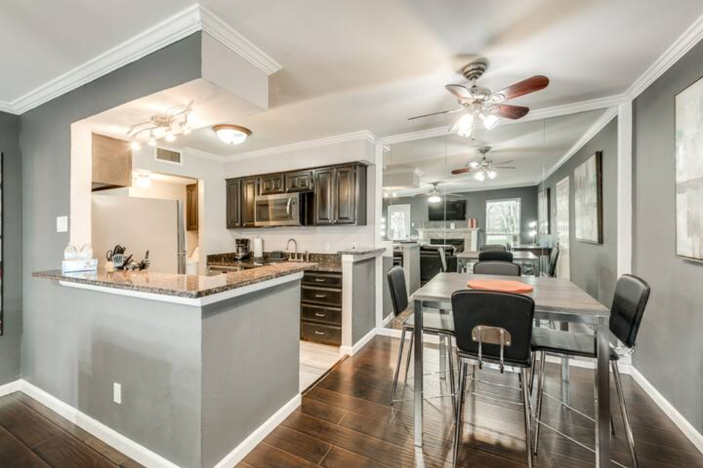 a kitchen and dining room with a table and chairs