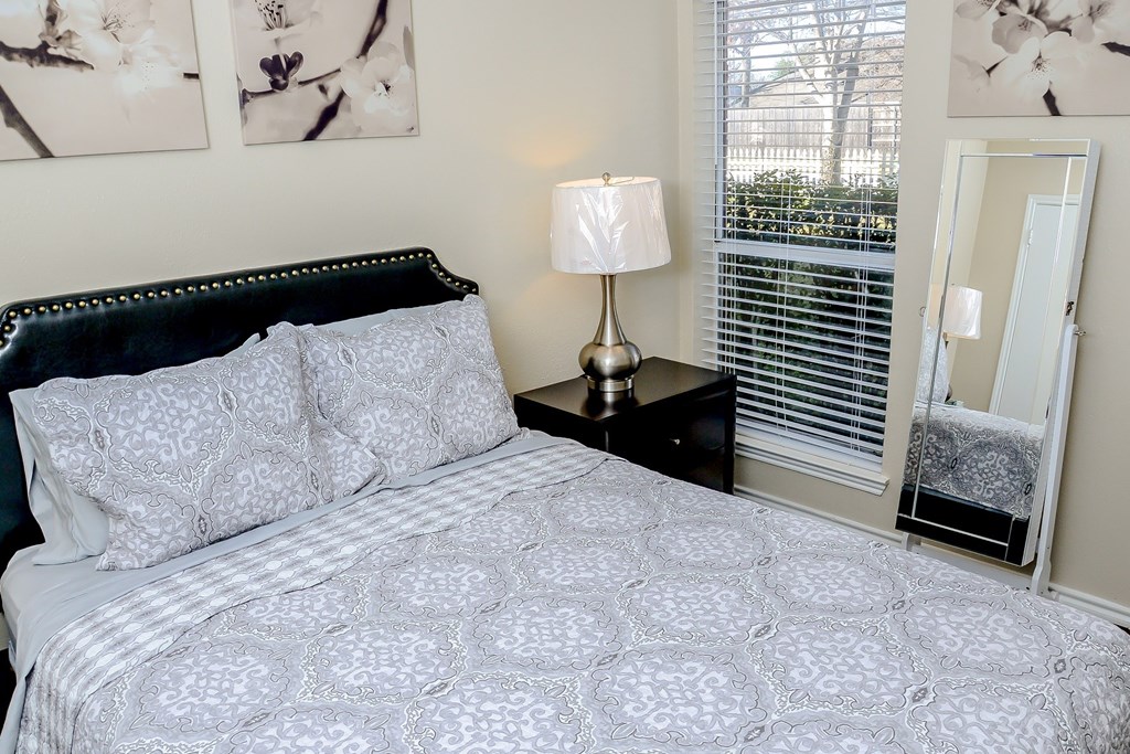 a bedroom with a large bed and a window