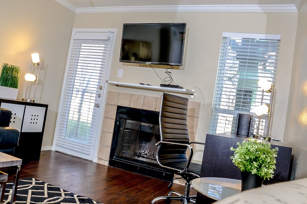 a living room with a fireplace and a tv on top of it