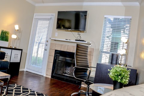 a living room with a fireplace and a tv on top of it