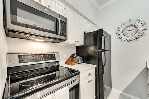 the kitchen of our two bedroom apartment atrium has stainless steel appliances and a microwave