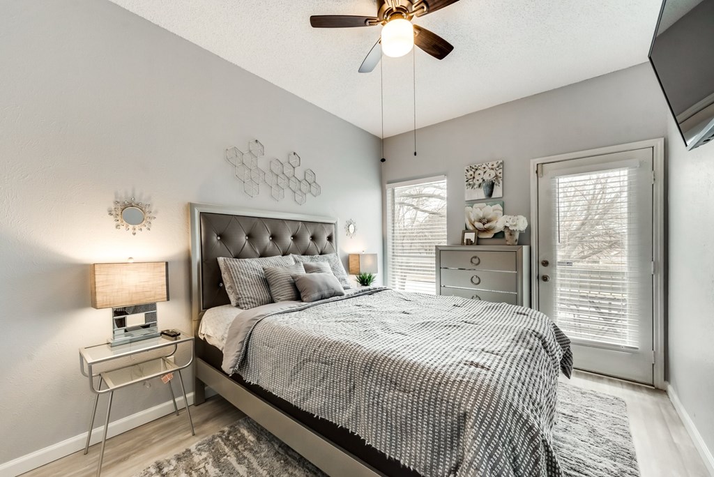 a bedroom with a bed and a ceiling fan