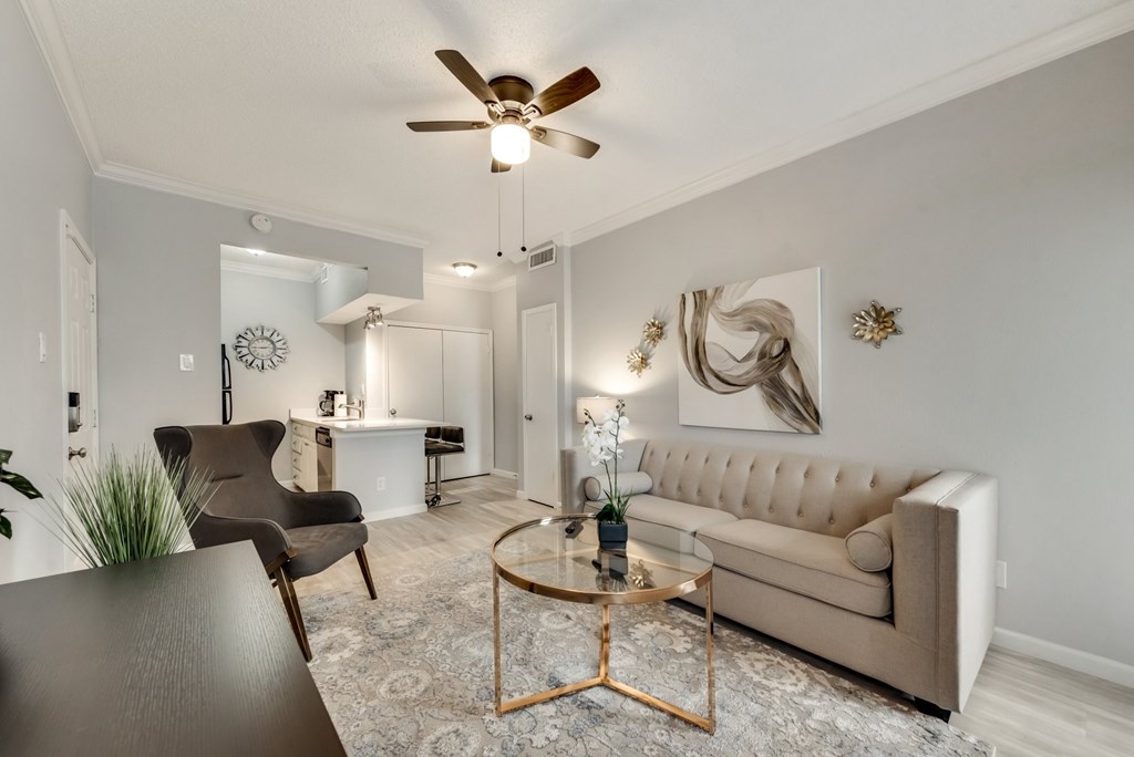 a living room with a ceiling fan and a couch
