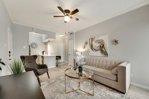 a living room with a ceiling fan and a couch
