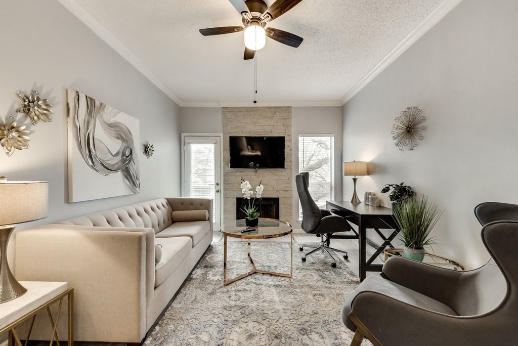 the living room of an apartment with a couch and a chair