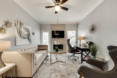 the living room of an apartment with a couch and a chair