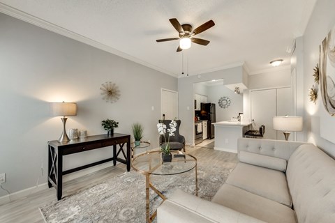a living room with a ceiling fan and a couch