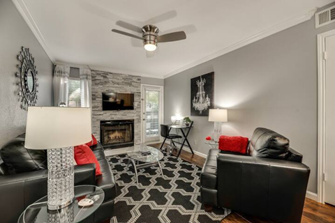 a living room with leather furniture and a fireplace