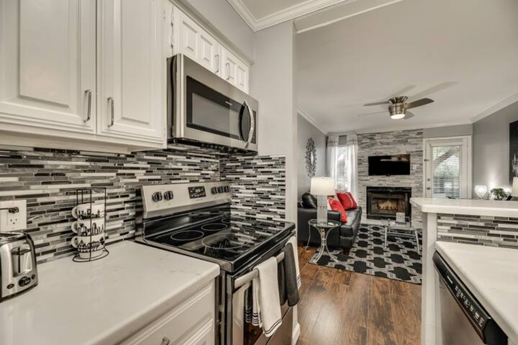 a kitchen with a stove top oven and a microwave