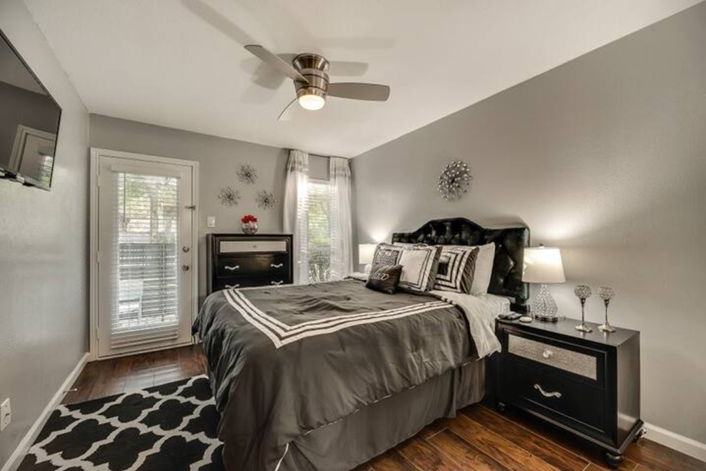 a bedroom with a bed and a ceiling fan