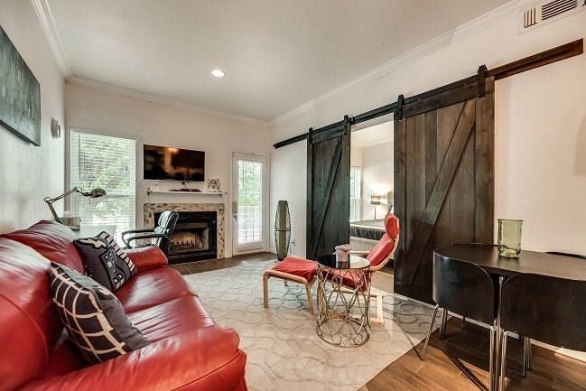 a living room with a leather couch and a fireplace
