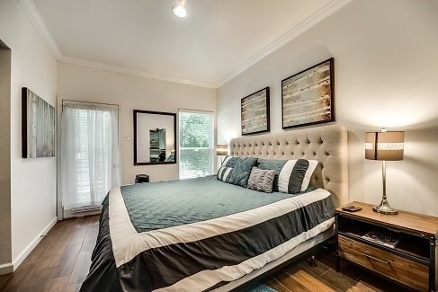 a bedroom with a bed and some pictures on the wall