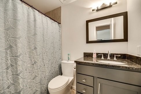 a bathroom with a toilet and a sink and a mirror