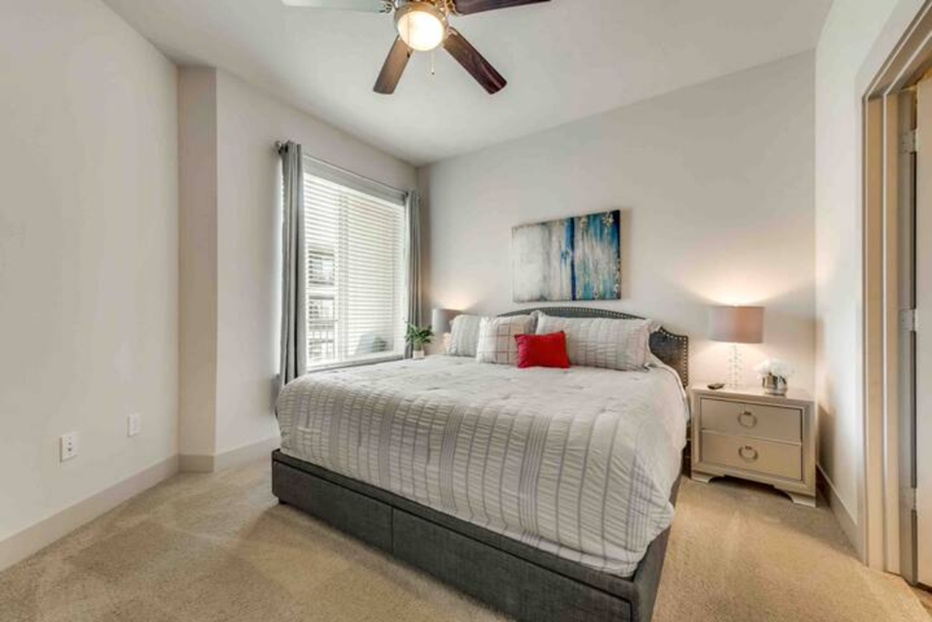 a bedroom with a bed and a ceiling fan