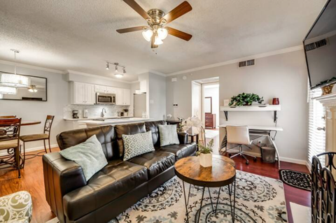 a living room with a leather couch and a coffee table