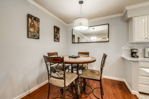 a dining room with a table and chairs