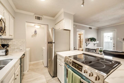 a kitchen with a stove and a refrigerator