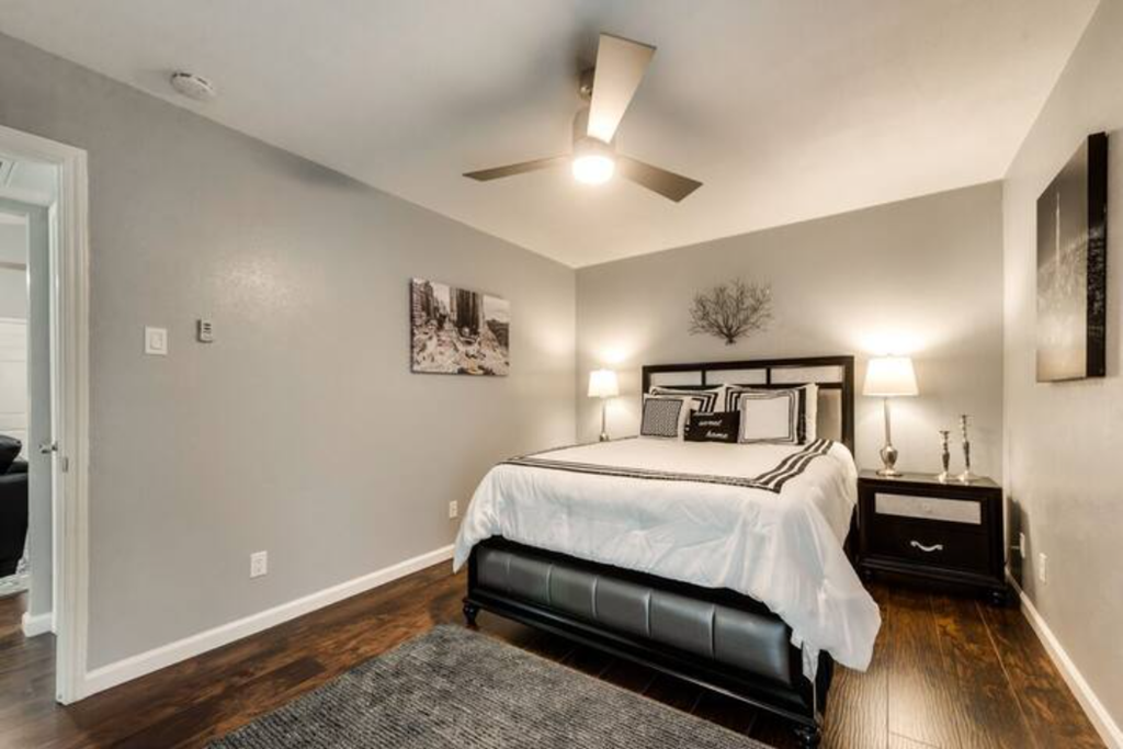 a bedroom with a bed and a ceiling fan