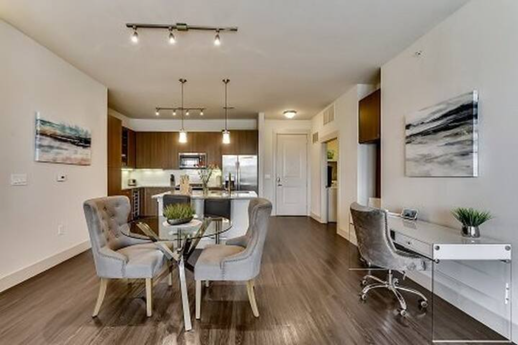 a living room and dining room with a table and chairs