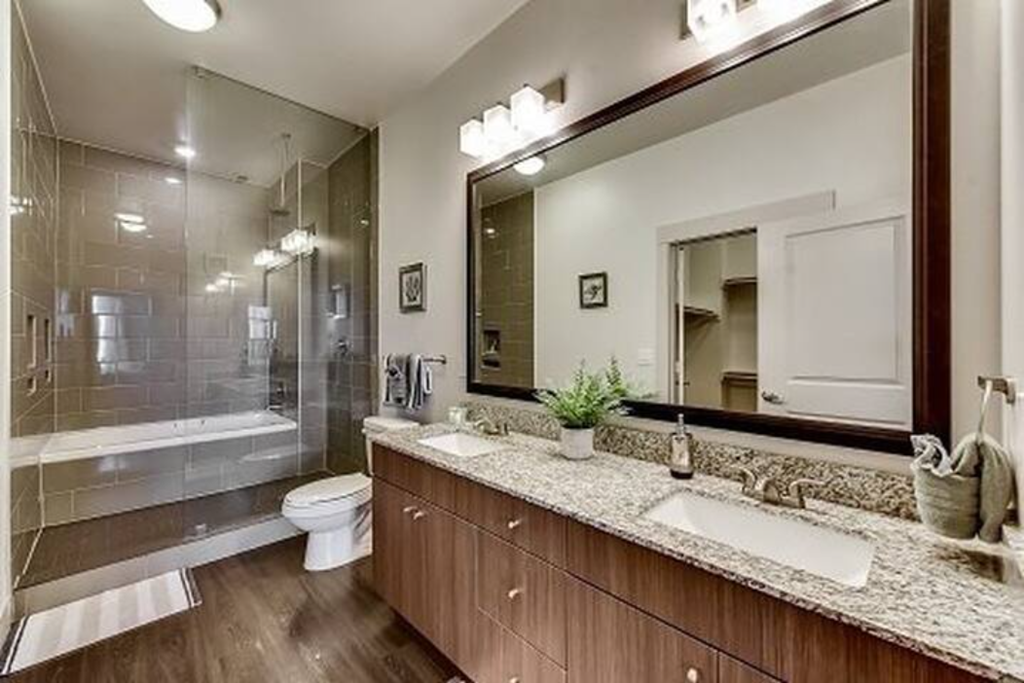 a bathroom with a toilet and a large mirror