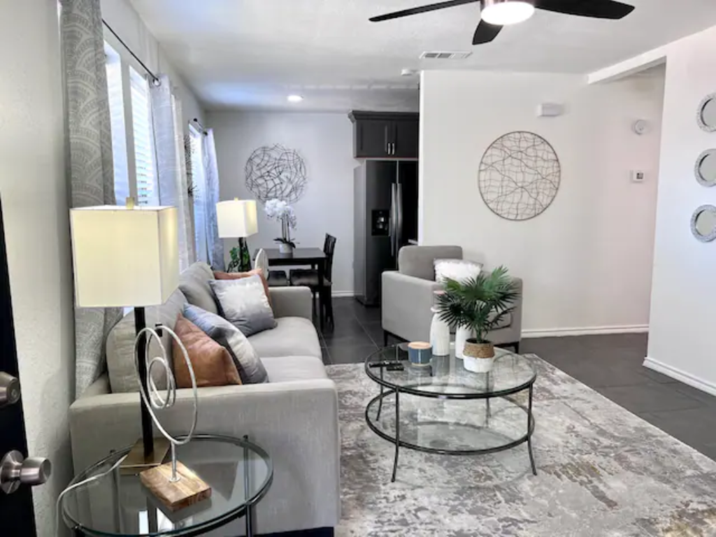 a living room with couches and a glass table