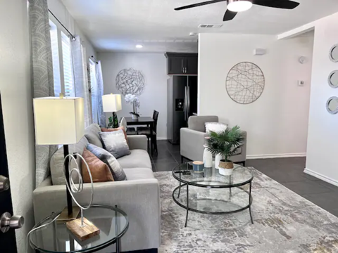 a living room with couches and a glass table