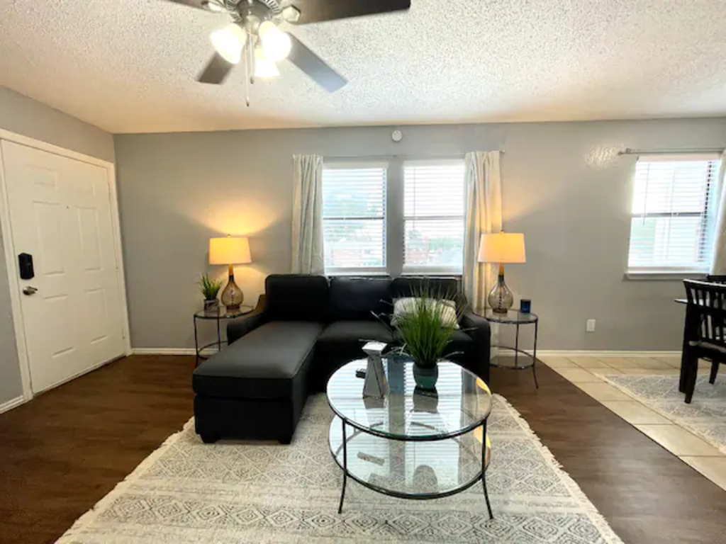a living room with a couch and a glass coffee table