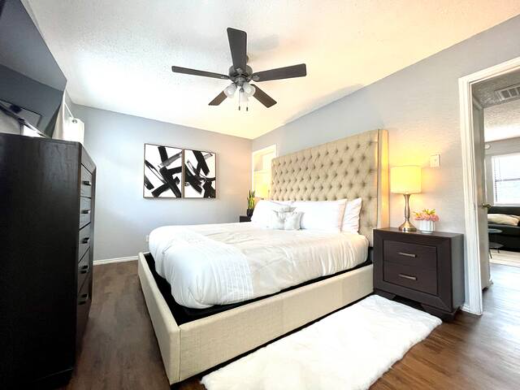 a bedroom with a bed and a ceiling fan