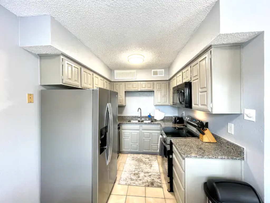 a kitchen with stainless steel appliances and white cabinets