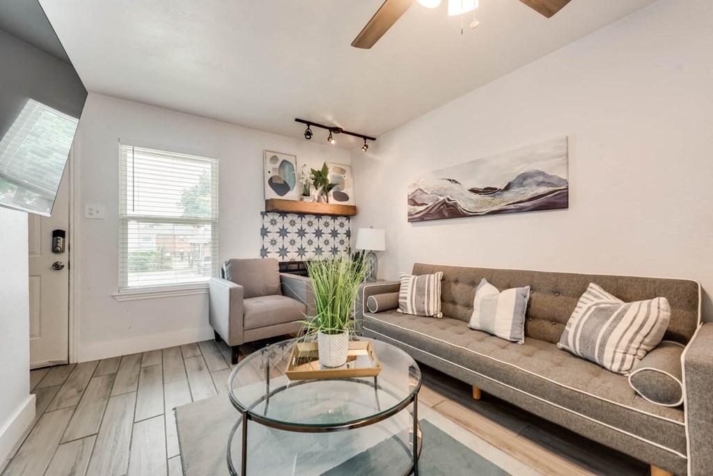 a living room with a couch and a glass coffee table