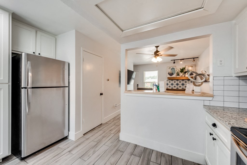 the kitchen is open to the living room and has stainless steel appliances